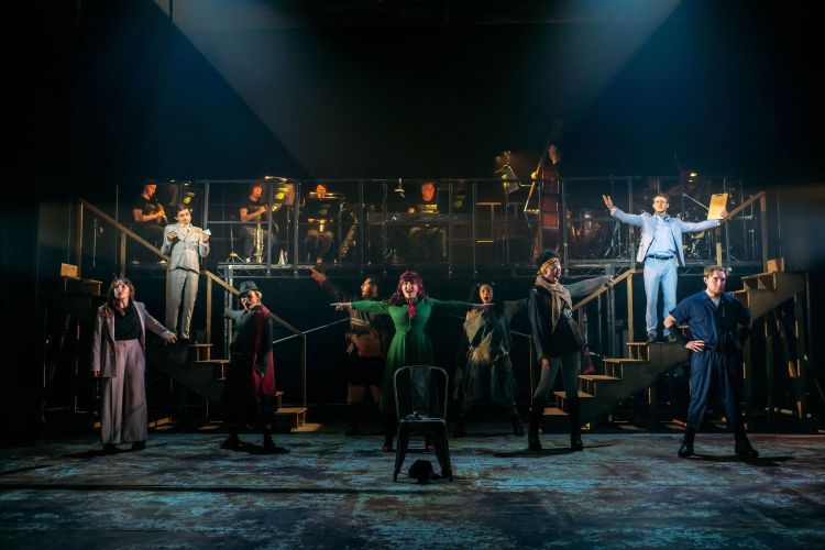 Urinetown production image showing the cast in a large group on stage